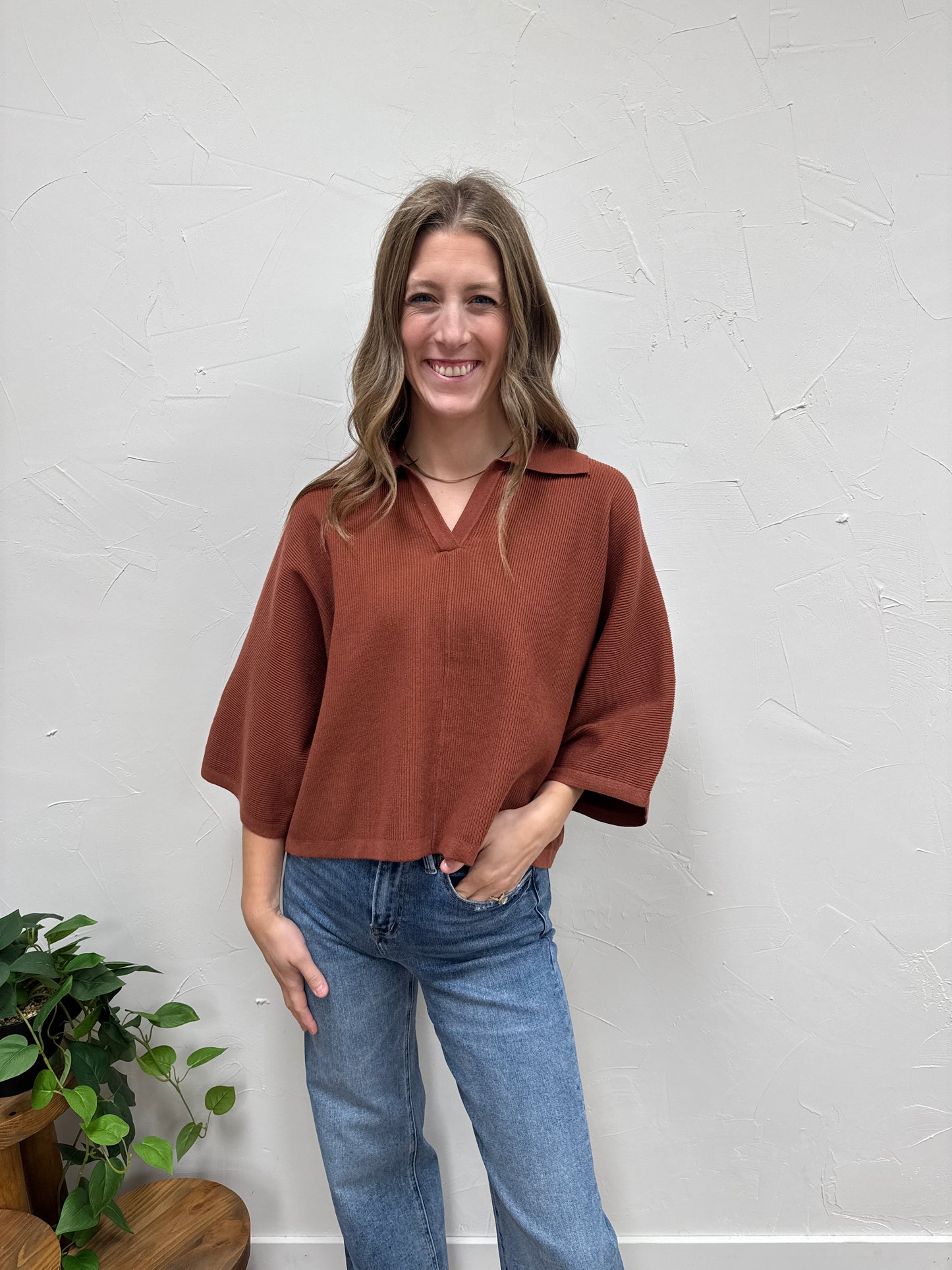 Solid 3/4 sleeve knit top with open V-neck collar