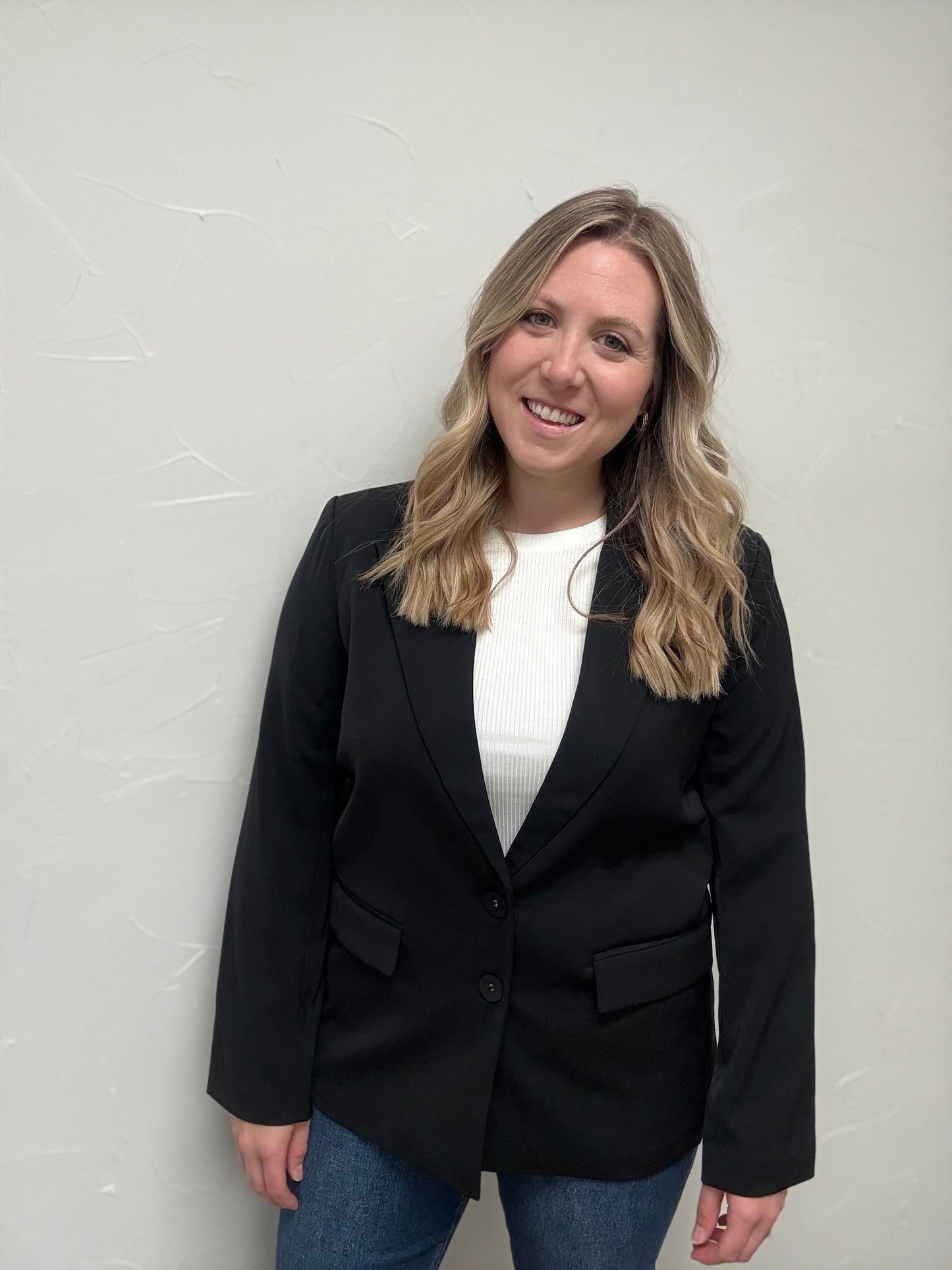 Solid blazer featuring pockets at front