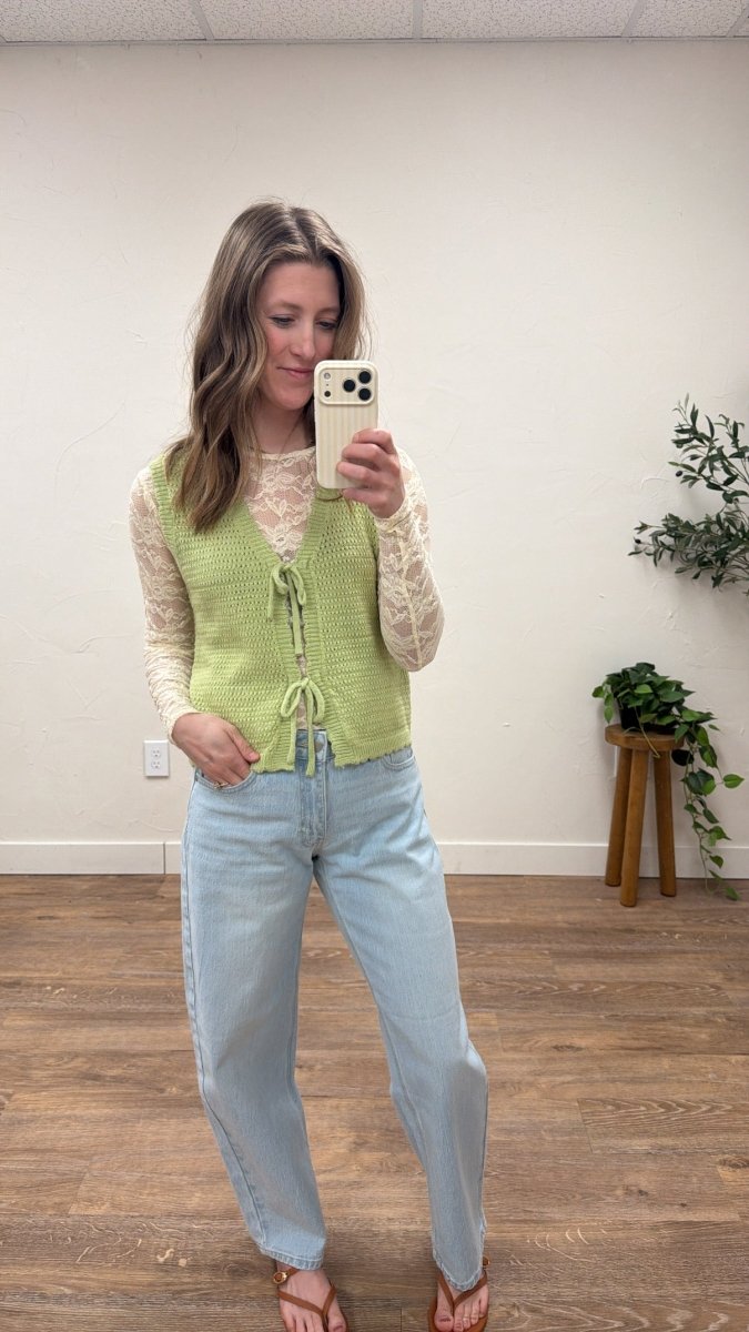 Lifestyle shot of model wearing bow tie front sweater vest styled casually — Three:Twelve Boutique