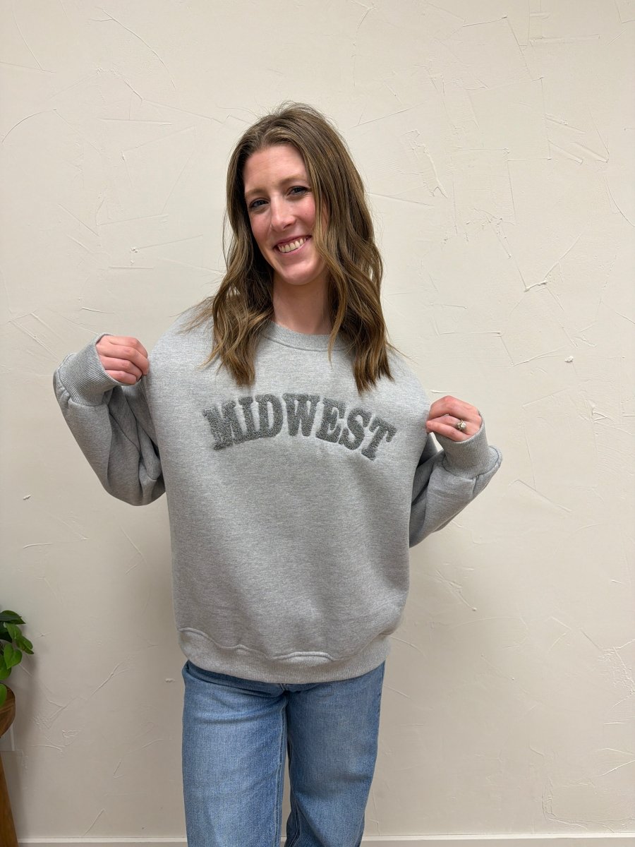 Lifestyle shot of model wearing Midwest Sweatshirt with casual denim pants - Three:Twelve Boutique