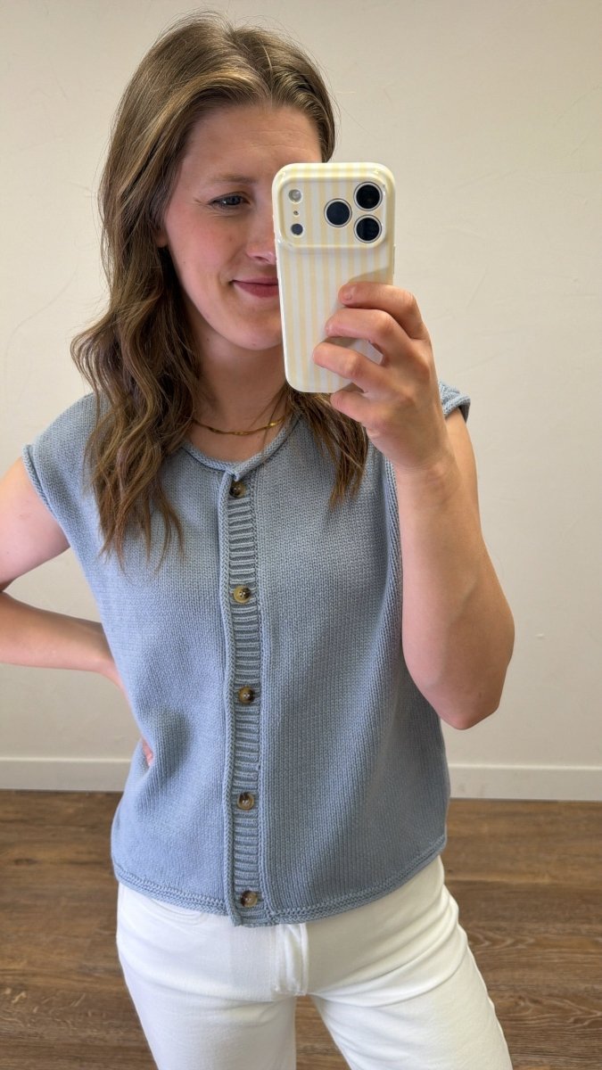 Close-up front view of model wearing Raw Edge Sleeveless Button Down Knit Cardigan showcasing raw edge detailing and button-front design
