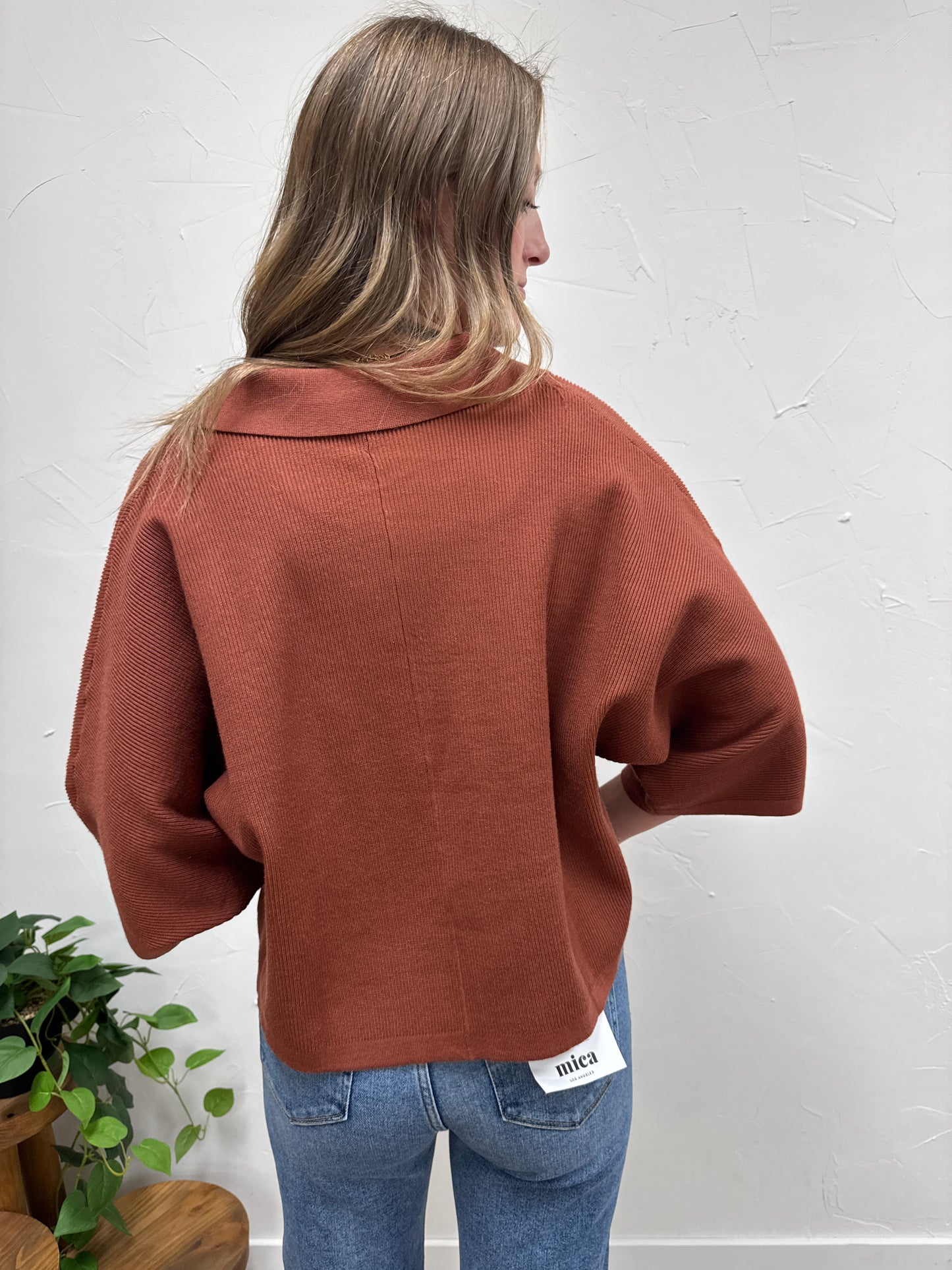 Solid 3/4 sleeve knit top with open V-neck collar