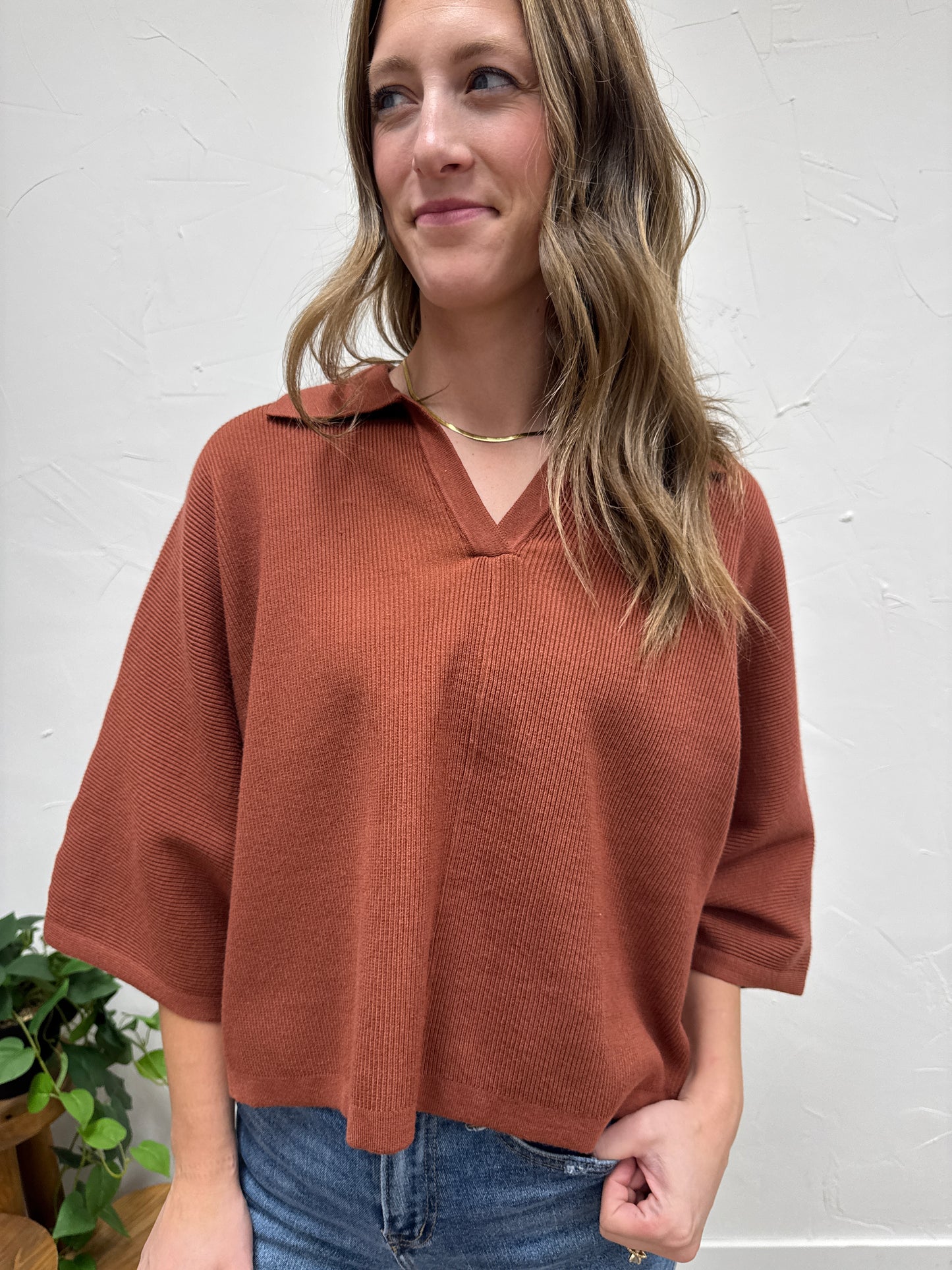 Solid 3/4 sleeve knit top with open V-neck collar