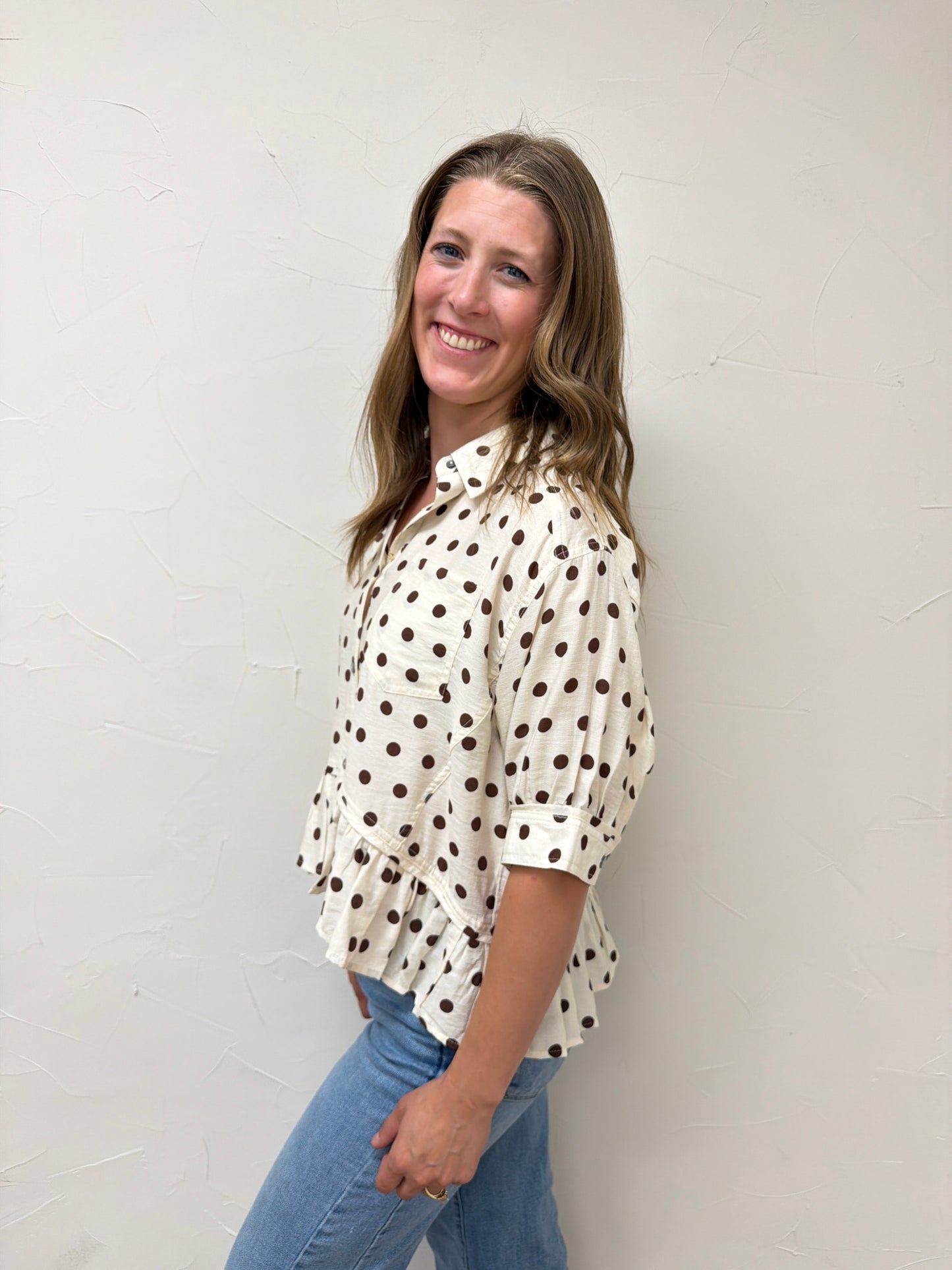 Polka dot waist-length top featuring ruffle hem