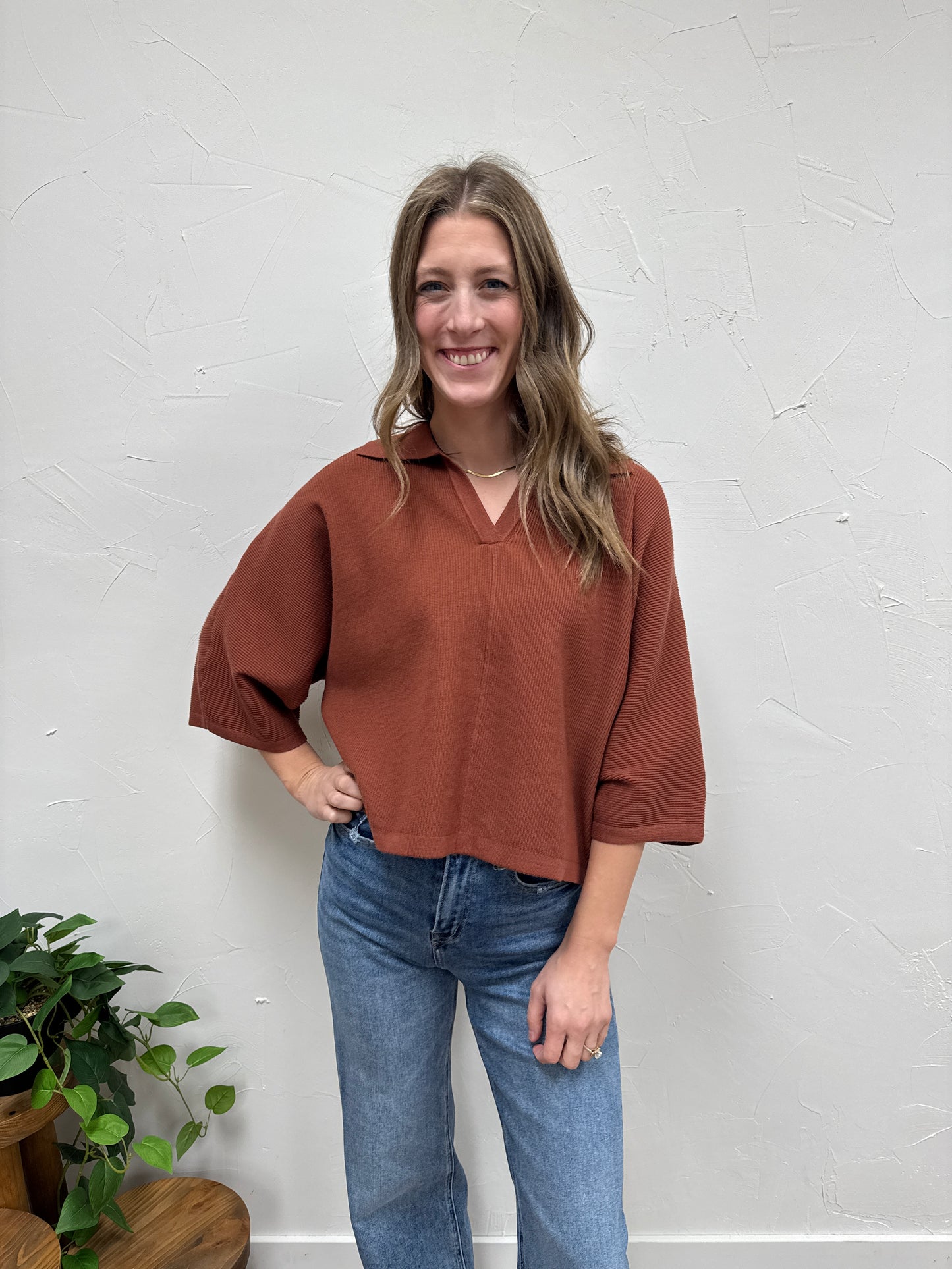 Solid 3/4 sleeve knit top with open V-neck collar