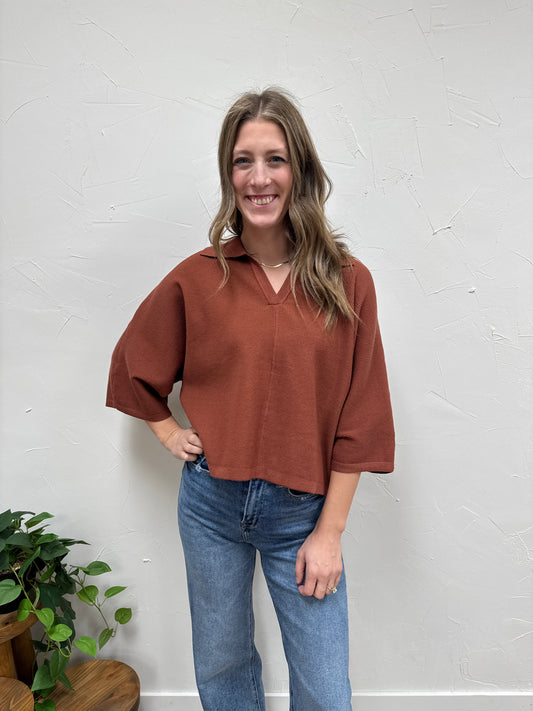 Solid 3/4 sleeve knit top with open V-neck collar