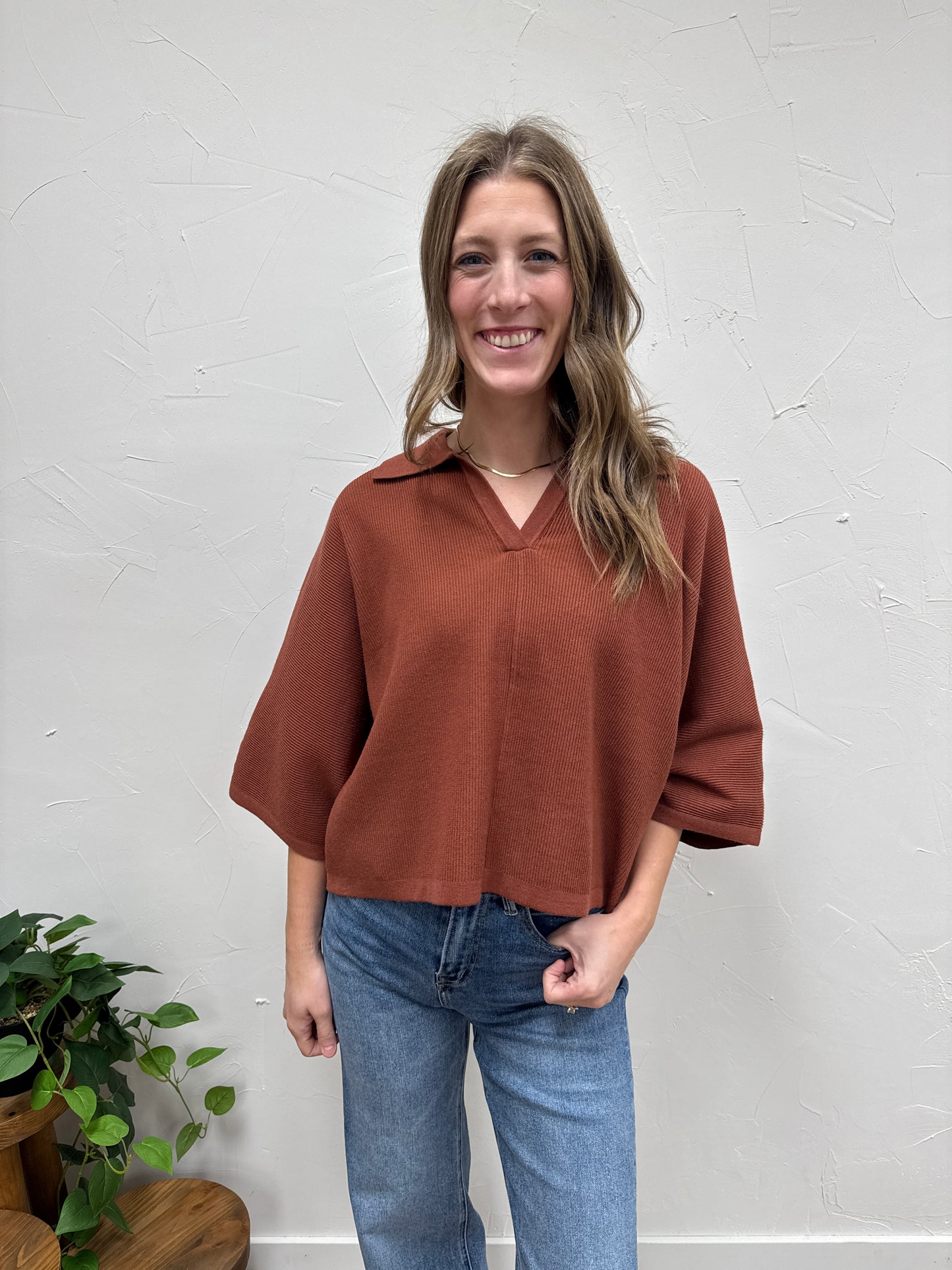 Solid 3/4 sleeve knit top with open V-neck collar