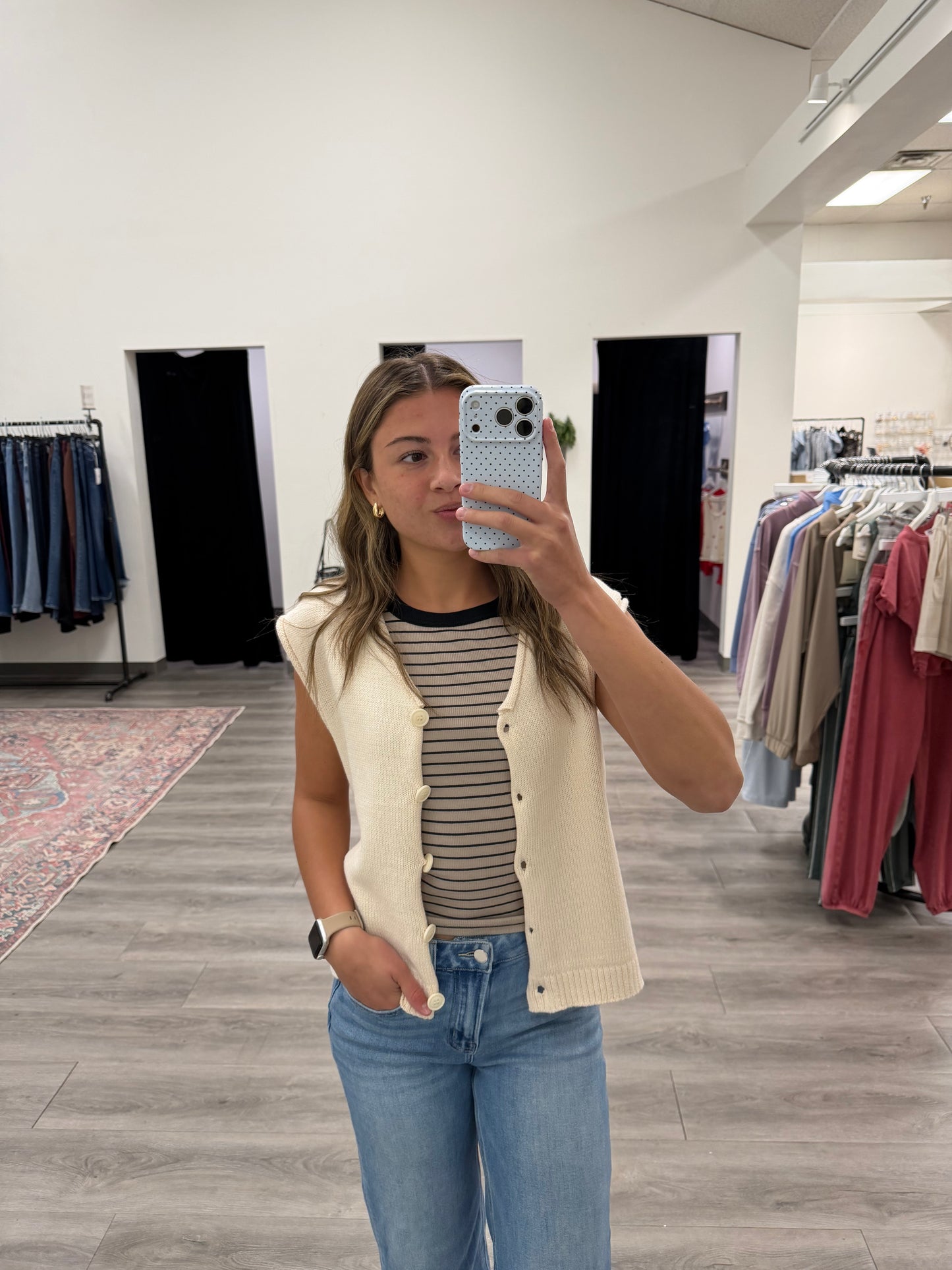 Front view of model wearing V-neck sweater vest cardigan layered over white shirt — Three:Twelve Boutique