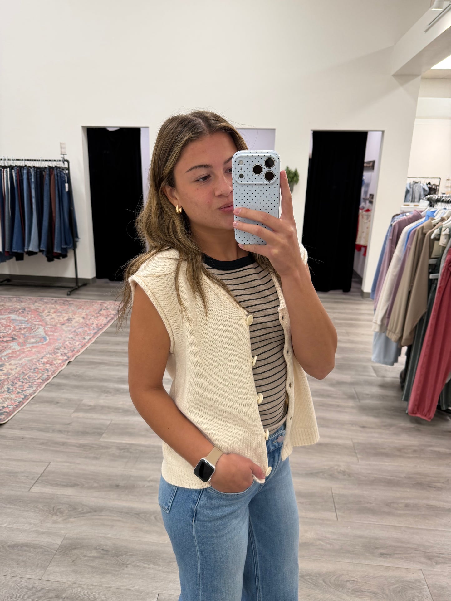Side angle view of sleeveless V-neck knit vest cardigan showing structured fit — Three:Twelve Boutique