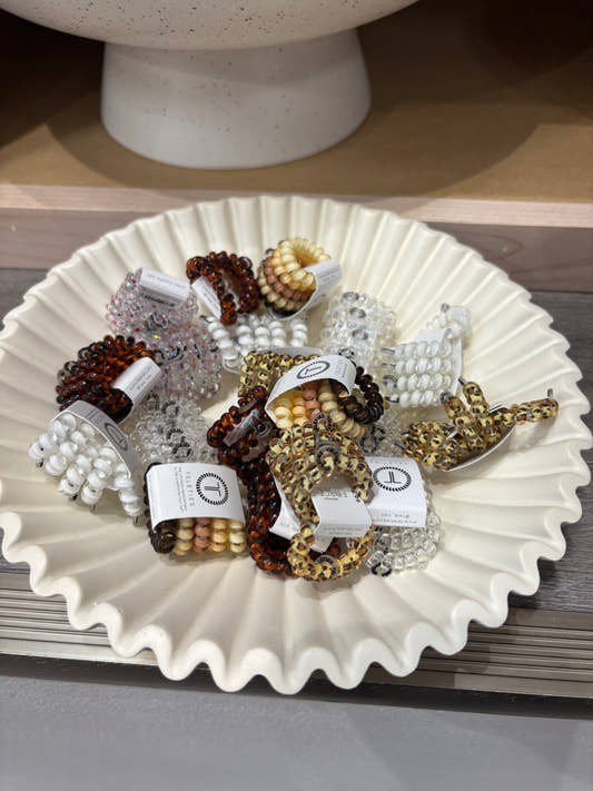 Group display of TELETIES tiny hair ties arranged in packaging — Three:Twelve Boutique