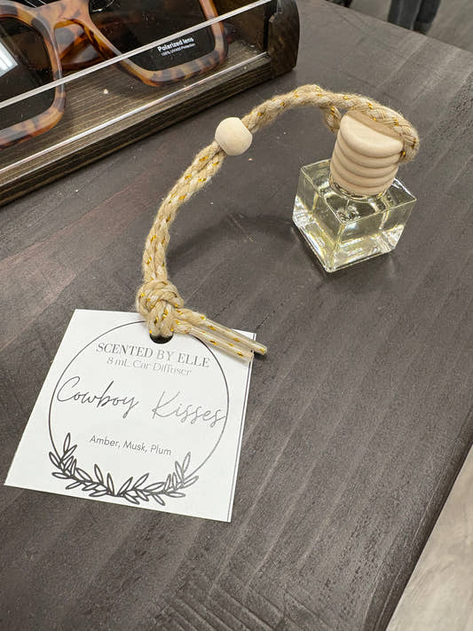 Front view of Cowboy Kisses car diffuser bottle with hanging cord — Three:Twelve Boutique