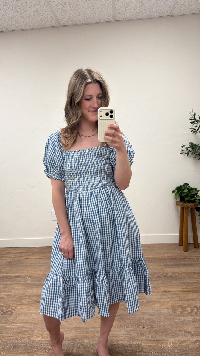 Front view of model wearing Alice gingham dress with puff sleeves and smocked chest — Three:Twelve Boutique