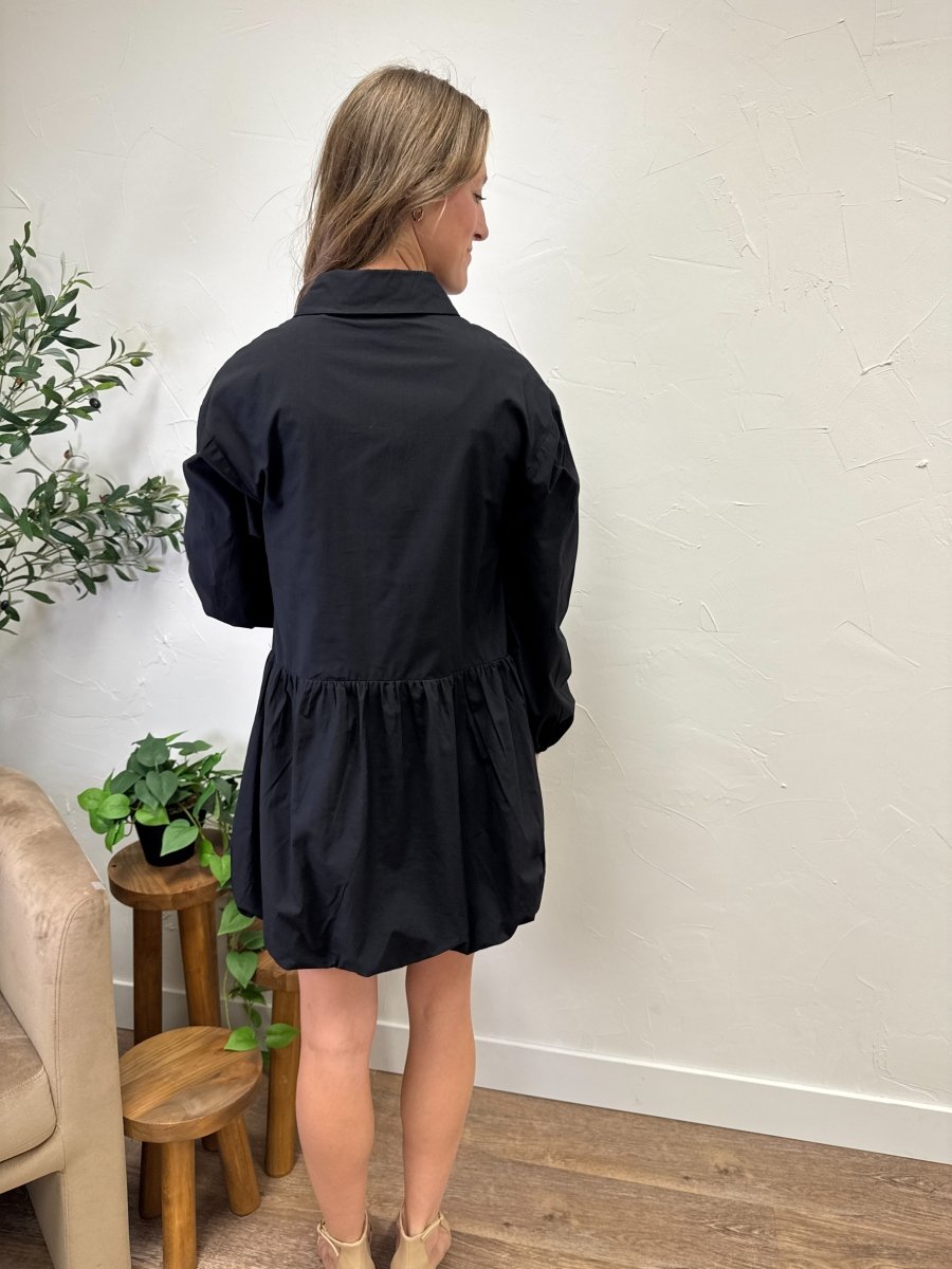 Back view of balloon bottom mini dress on model showing loose fit shape — Three:Twelve Boutique