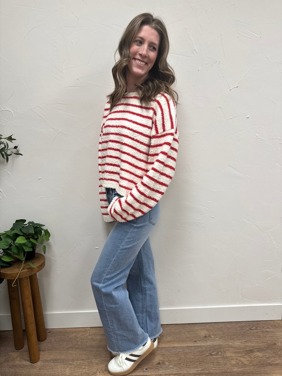Side angle view of striped knit sweater showing drape and sleeve length — Three:Twelve Boutique