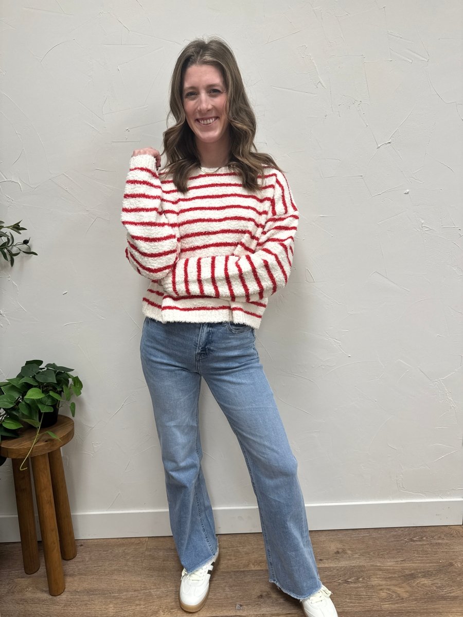 Lifestyle shot of model wearing striped sweater styled with casual denim outfit — Three:Twelve Boutique