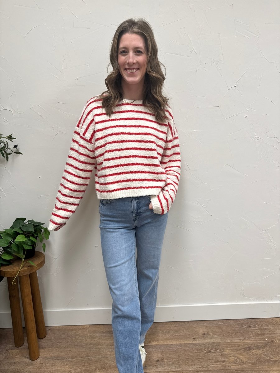 Lifestyle shot of model wearing striped sweater styled with casual denim outfit — Three:Twelve Boutique