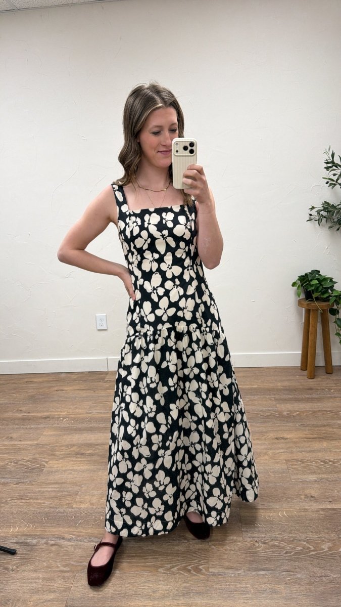 Front view of model wearing bold floral drop waist maxi dress with flowing silhouette — Three:Twelve Boutique
