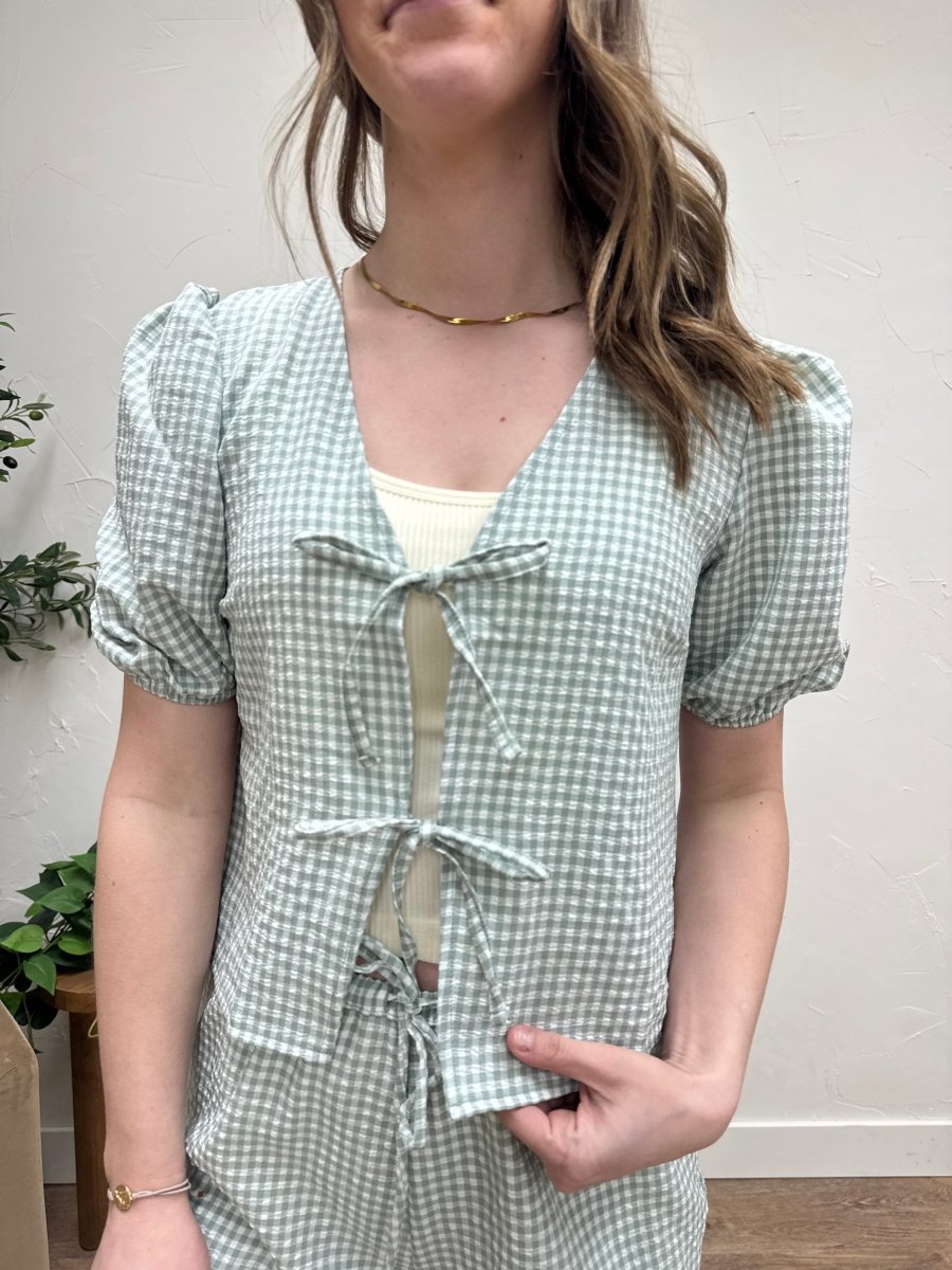 Front view of model wearing bow front gingham top with tie detail — Three:Twelve Boutique