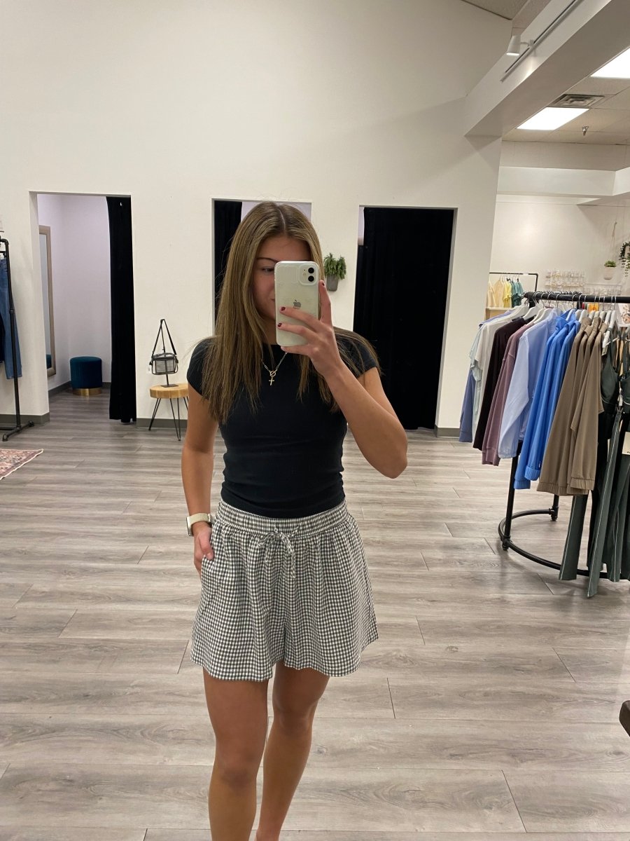 Front view of model wearing Caelis gingham shorts showing relaxed fit — Three:Twelve Boutique