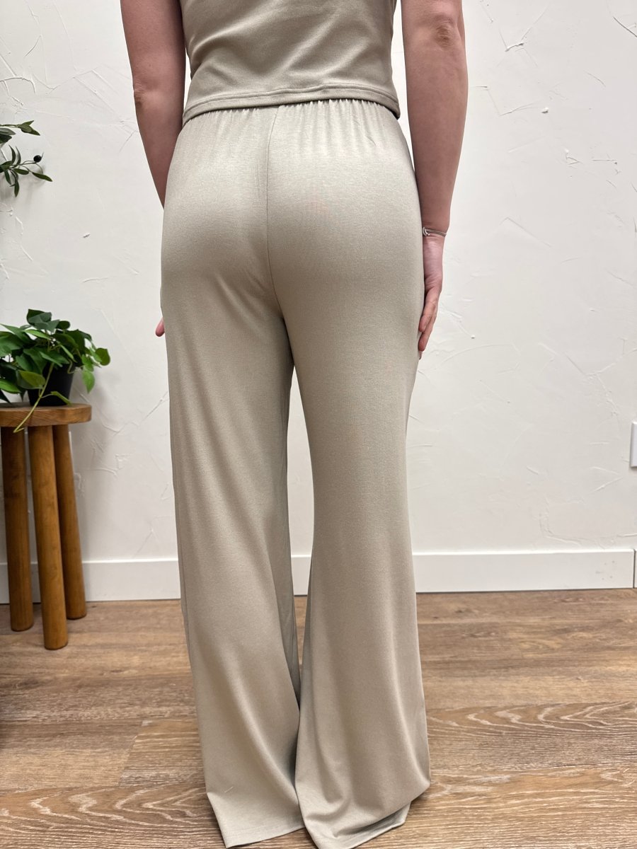 Back view of model wearing casual wide leg pants highlighting full length and loose silhouette — Three:Twelve Boutique