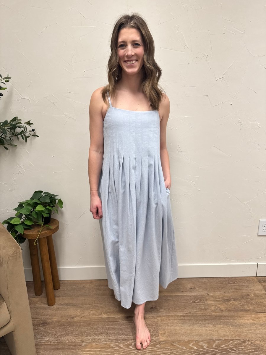 Lifestyle shot of model wearing midi dress styled for casual warm weather look — Three:Twelve Boutique