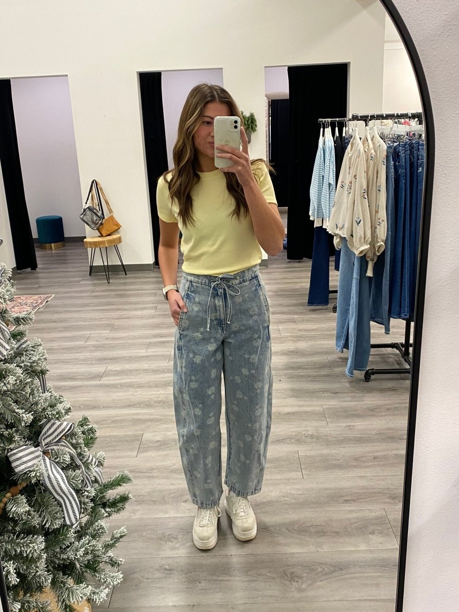 Lifestyle shot of model wearing denim jeans styled with casual top — Three:Twelve Boutique