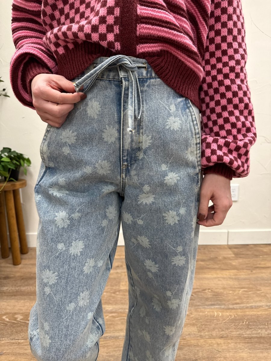 Close up of washed denim texture and drawstring waistband detail — Three:Twelve Boutique