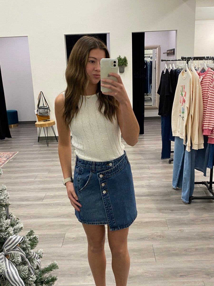 Lifestyle shot of model wearing denim mini skirt styled with casual top — Three:Twelve Boutique