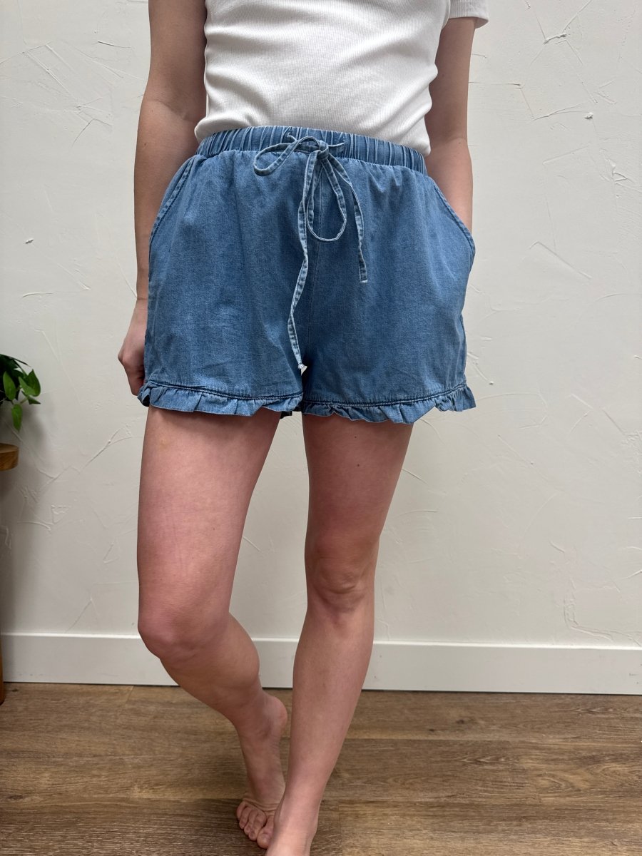 Close up of ruffle hem and frayed denim edge detail — Three:Twelve Boutique