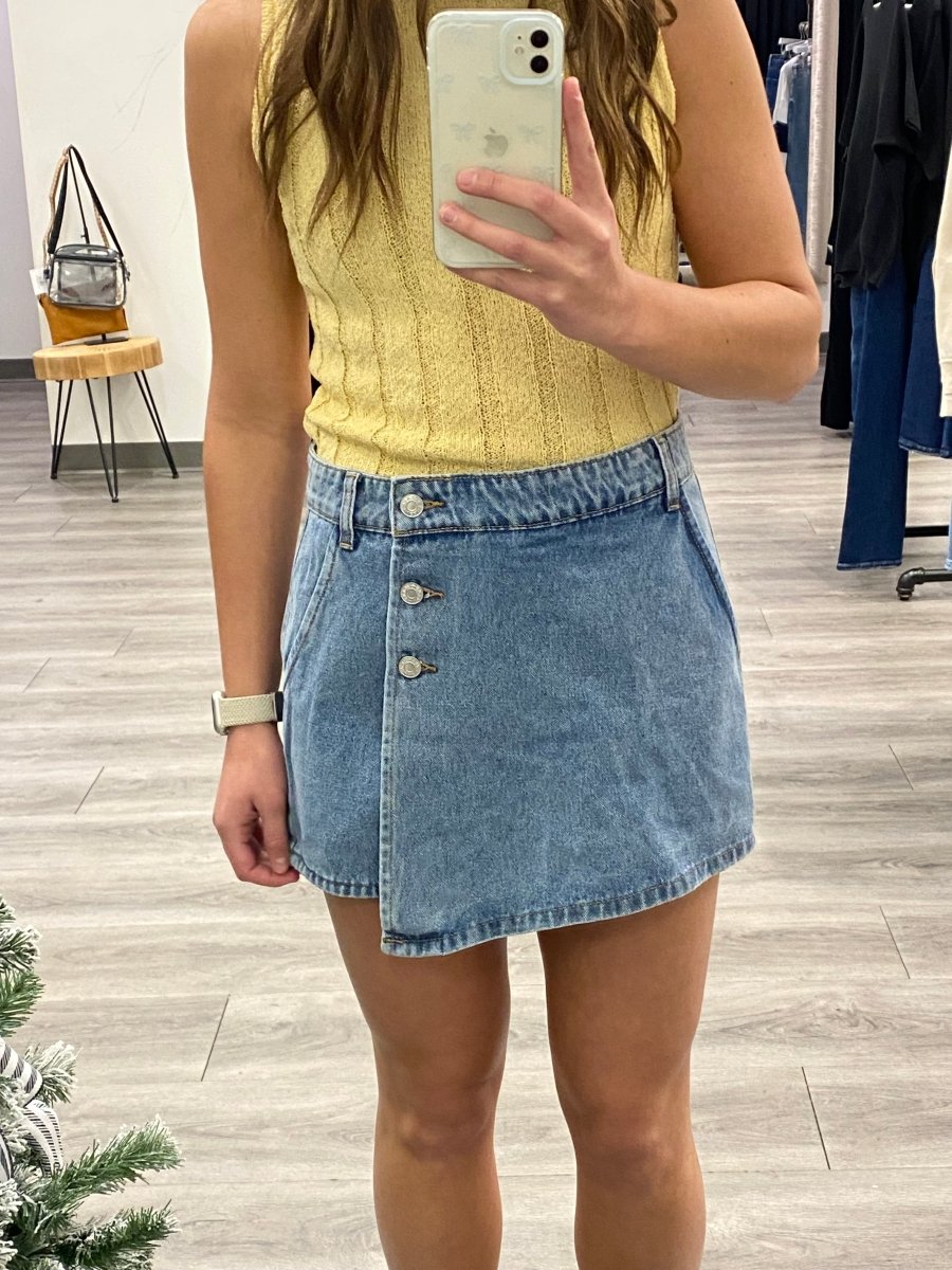 Front view of model wearing denim skort with classic mini skirt silhouette — Three:Twelve Boutique