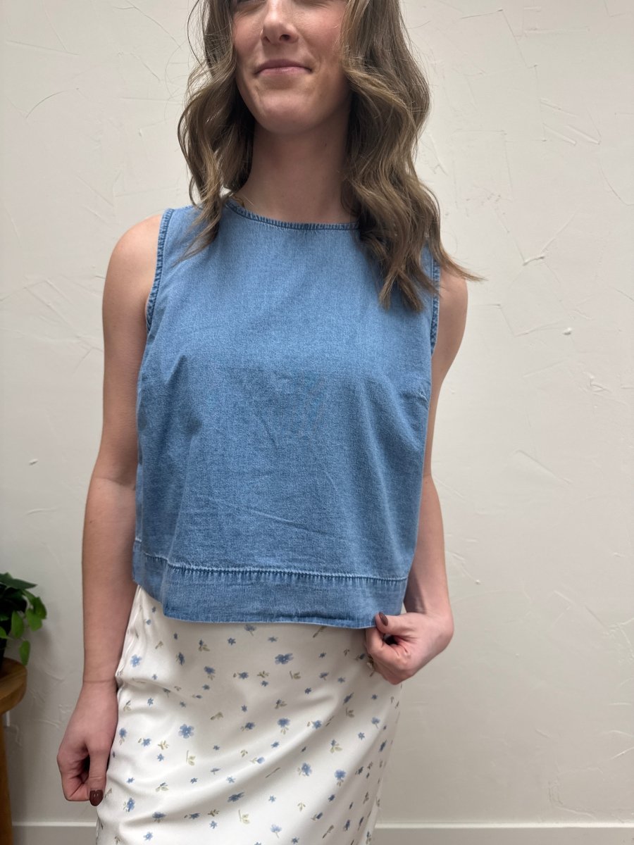 Front view of denim tank top on model showing sleeveless button front design — Three:Twelve Boutique