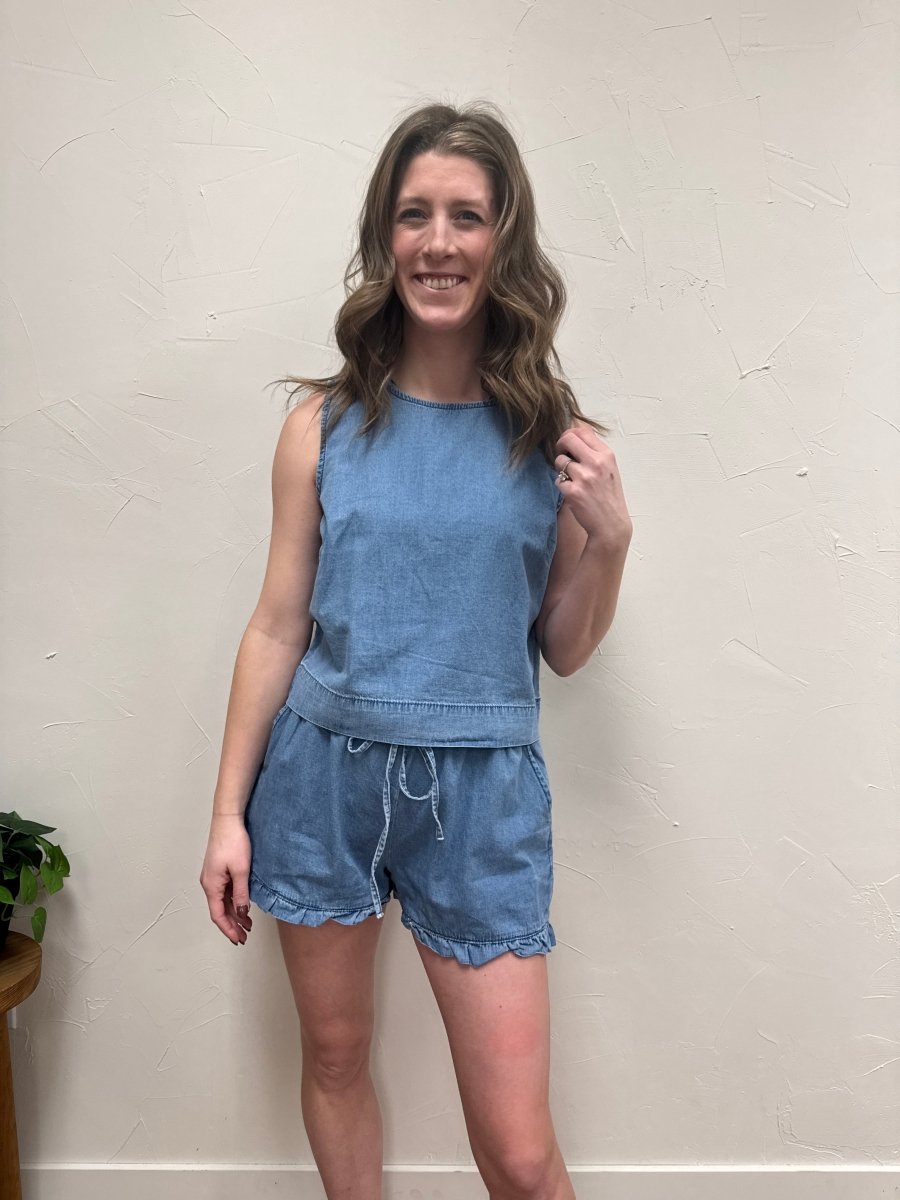Lifestyle shot of model wearing denim tank top styled with casual bottoms — Three:Twelve Boutique