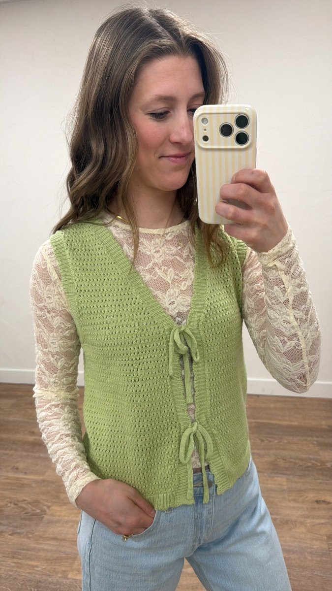 Lifestyle shot of model wearing bow tie front sweater vest styled casually — Three:Twelve Boutique