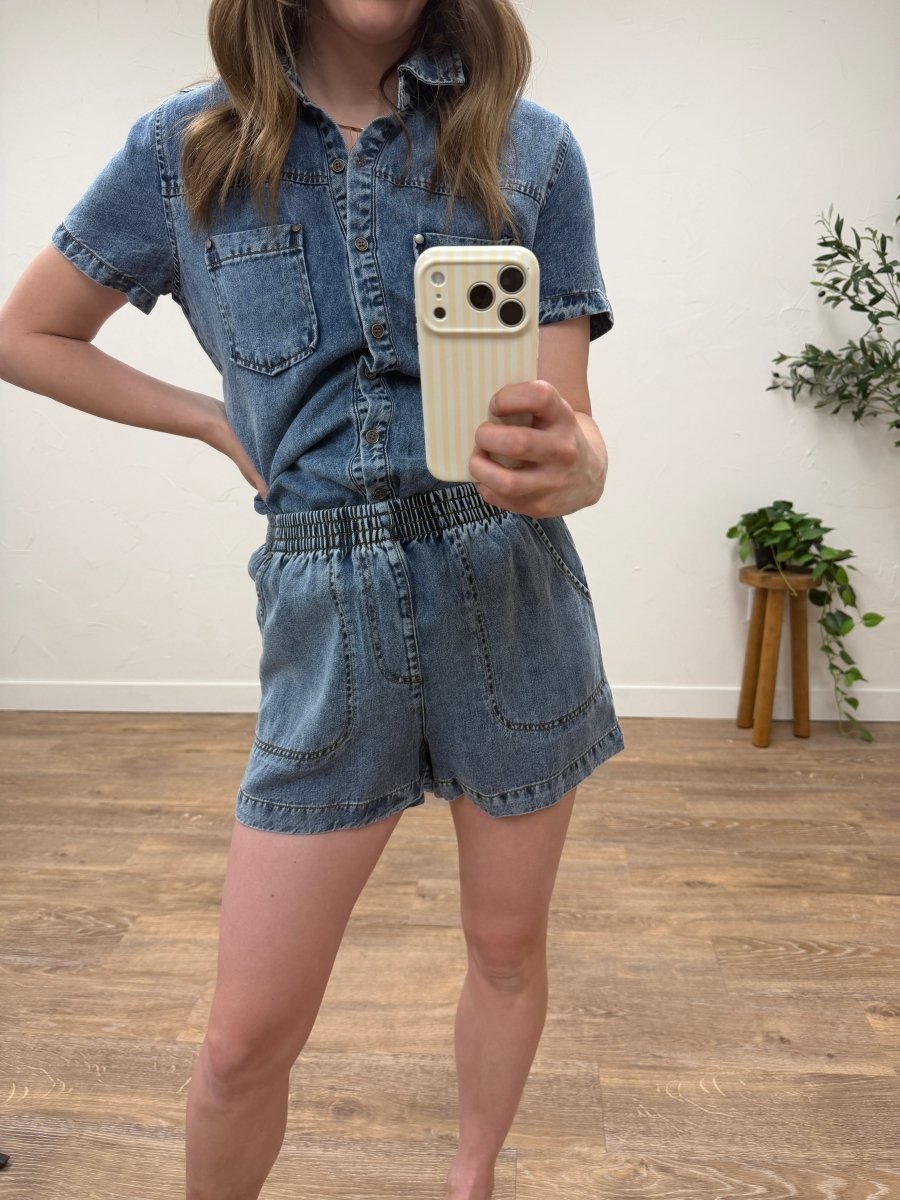 Front view of model wearing elastic waist chambray mini shorts in light blue — Three:Twelve Boutique