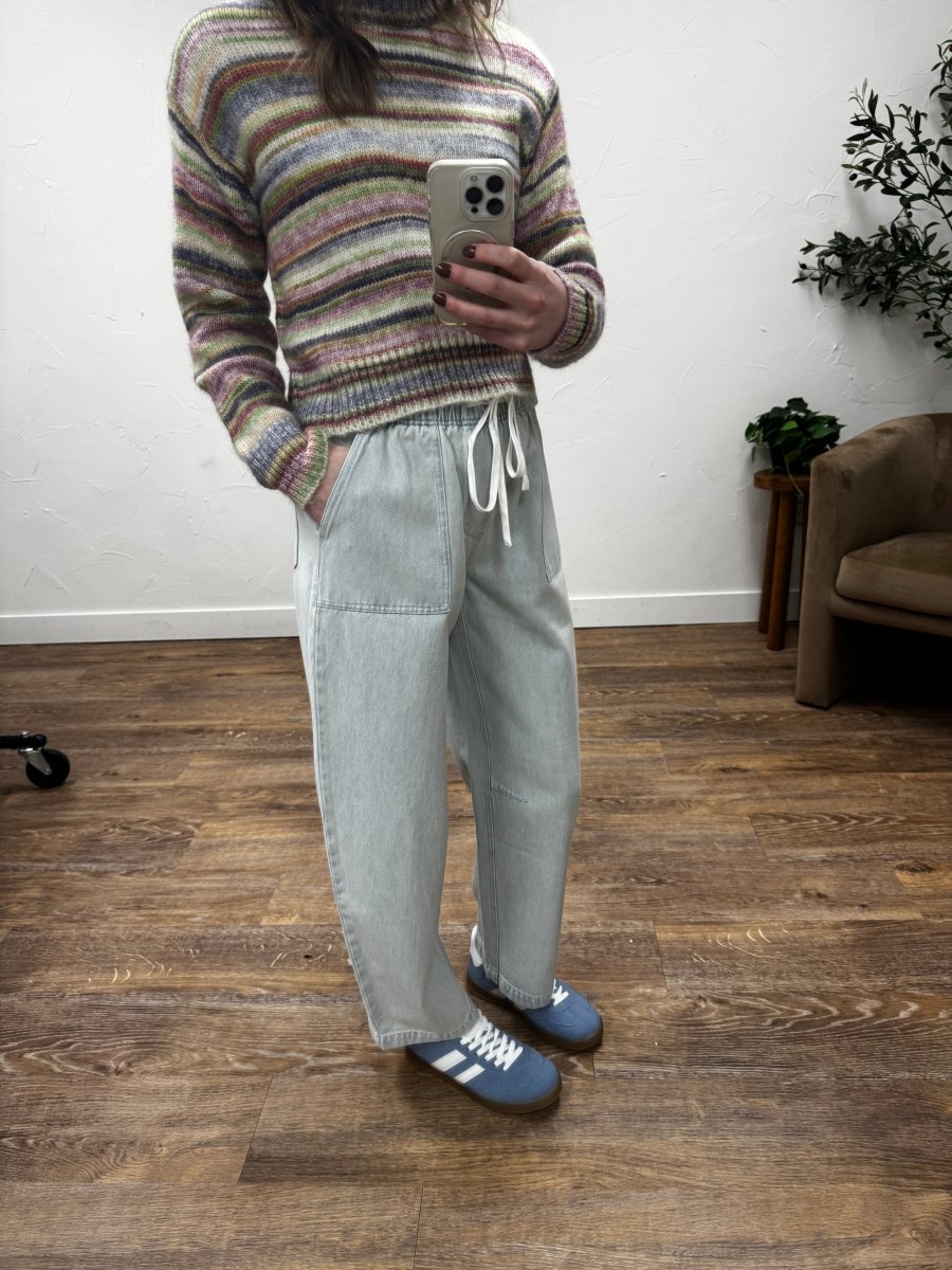 Lifestyle shot of model styling emerald pants with casual top — Three:Twelve Boutique