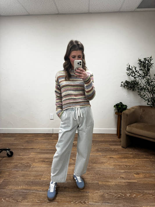 Lifestyle shot of model styling emerald pants with casual top — Three:Twelve Boutique