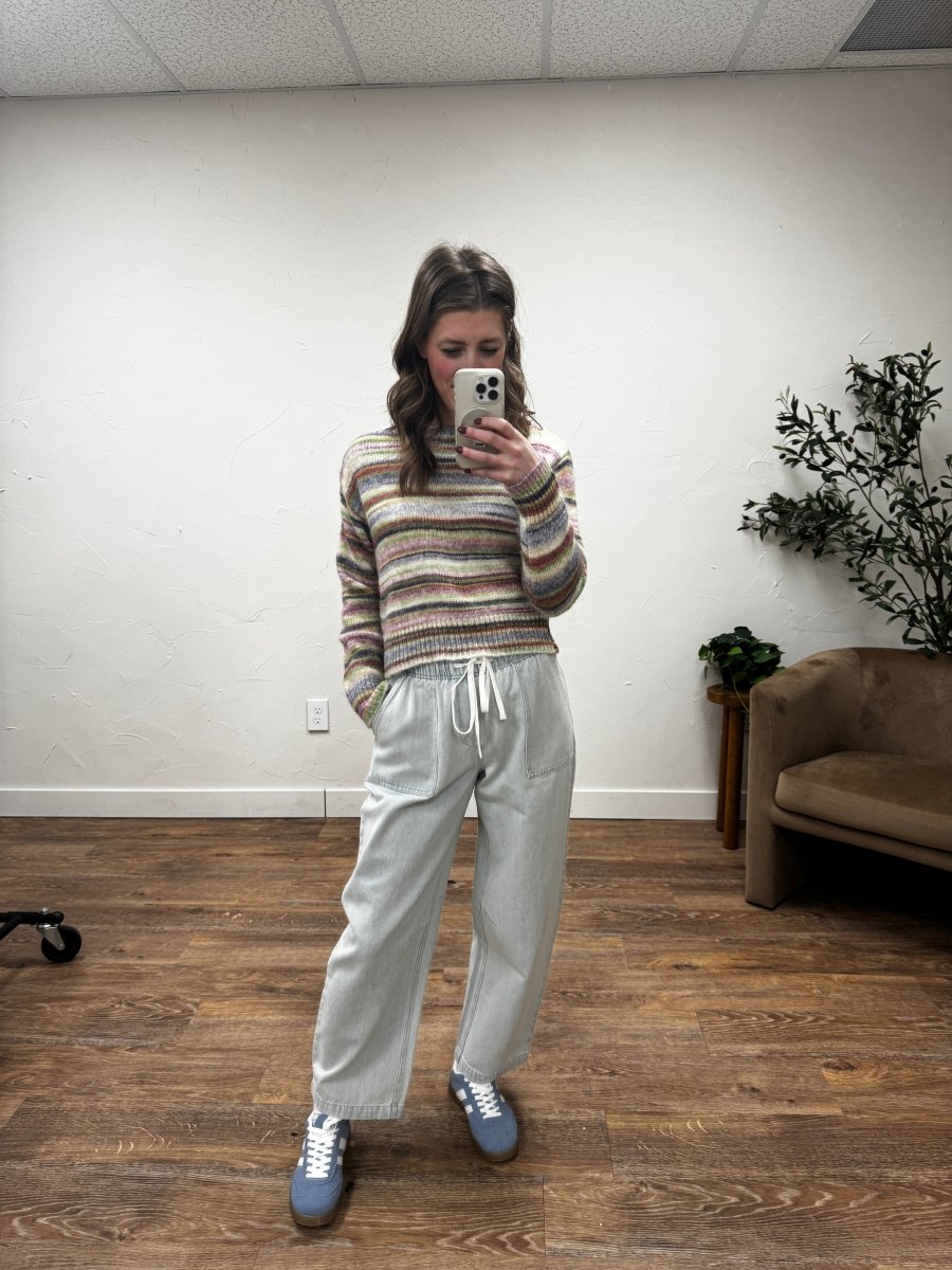 Lifestyle shot of model styling emerald pants with casual top — Three:Twelve Boutique