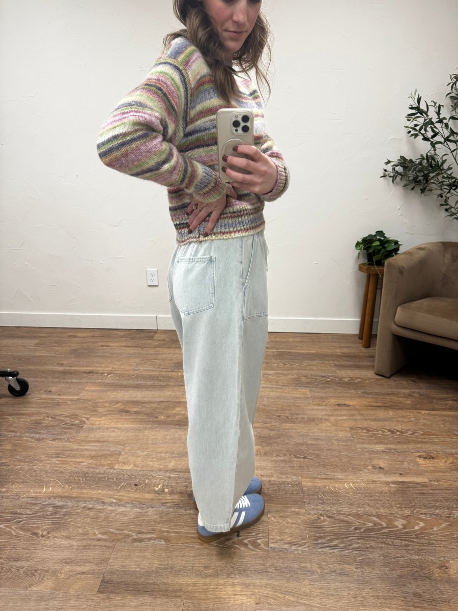Side view of emerald pants showing wide leg silhouette and drape — Three:Twelve Boutique