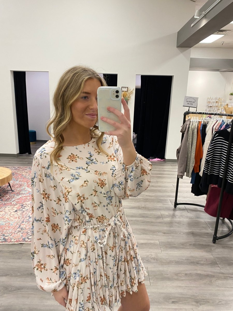 Front view of model wearing floral long sleeve mini dress with tie waist — Three:Twelve Boutique