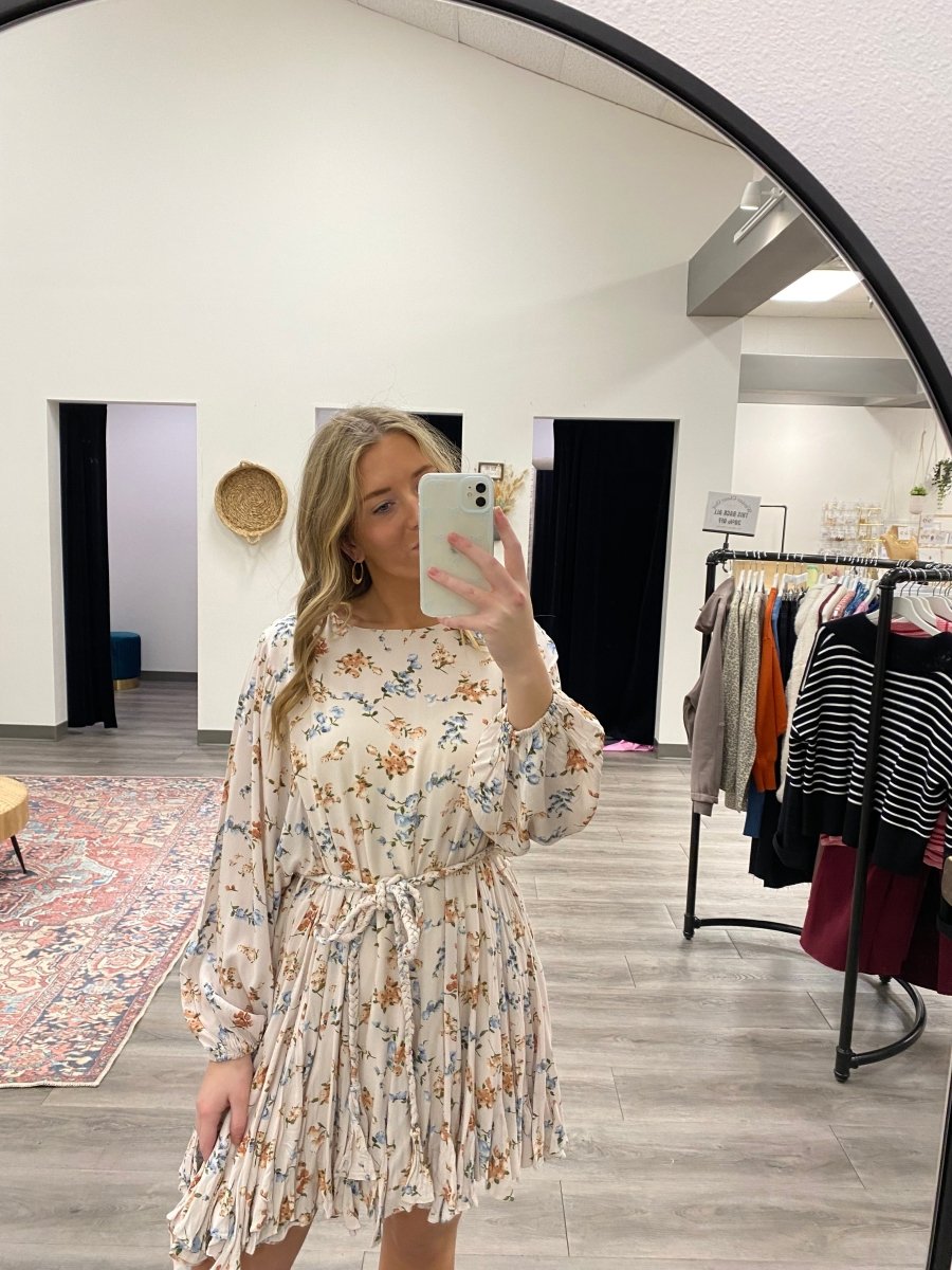 Front view of model wearing floral long sleeve mini dress with tie waist — Three:Twelve Boutique