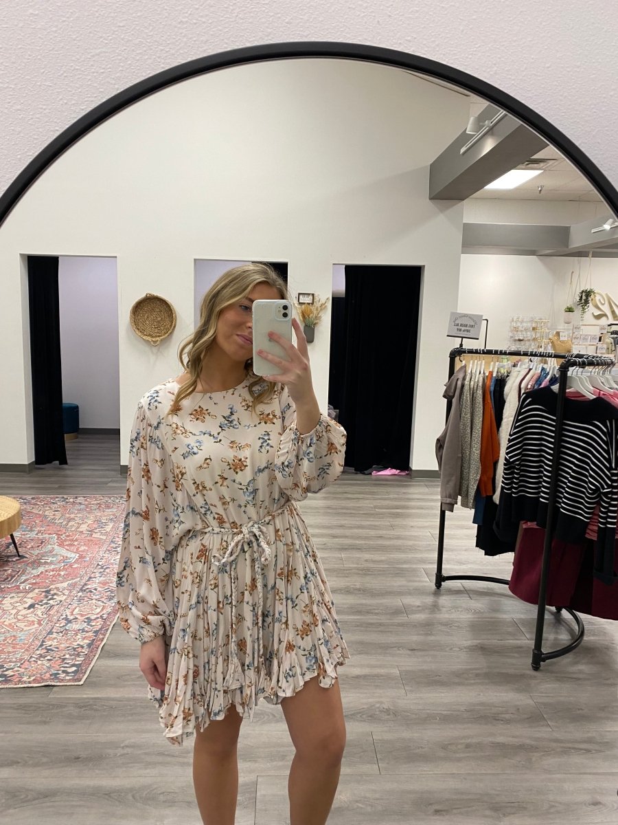 Lifestyle shot of model wearing floral mini dress styled casually — Three:Twelve Boutique
