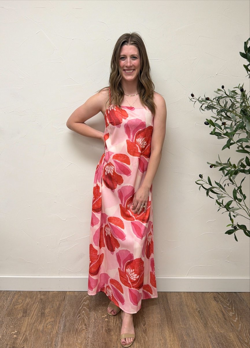 Lifestyle image of model wearing Floral Print Strap Linen Maxi Dress in casual summer setting — Three Boutique