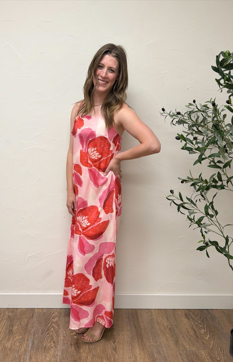 Lifestyle image of model wearing Floral Print Strap Linen Maxi Dress in casual summer setting — Three Boutique
