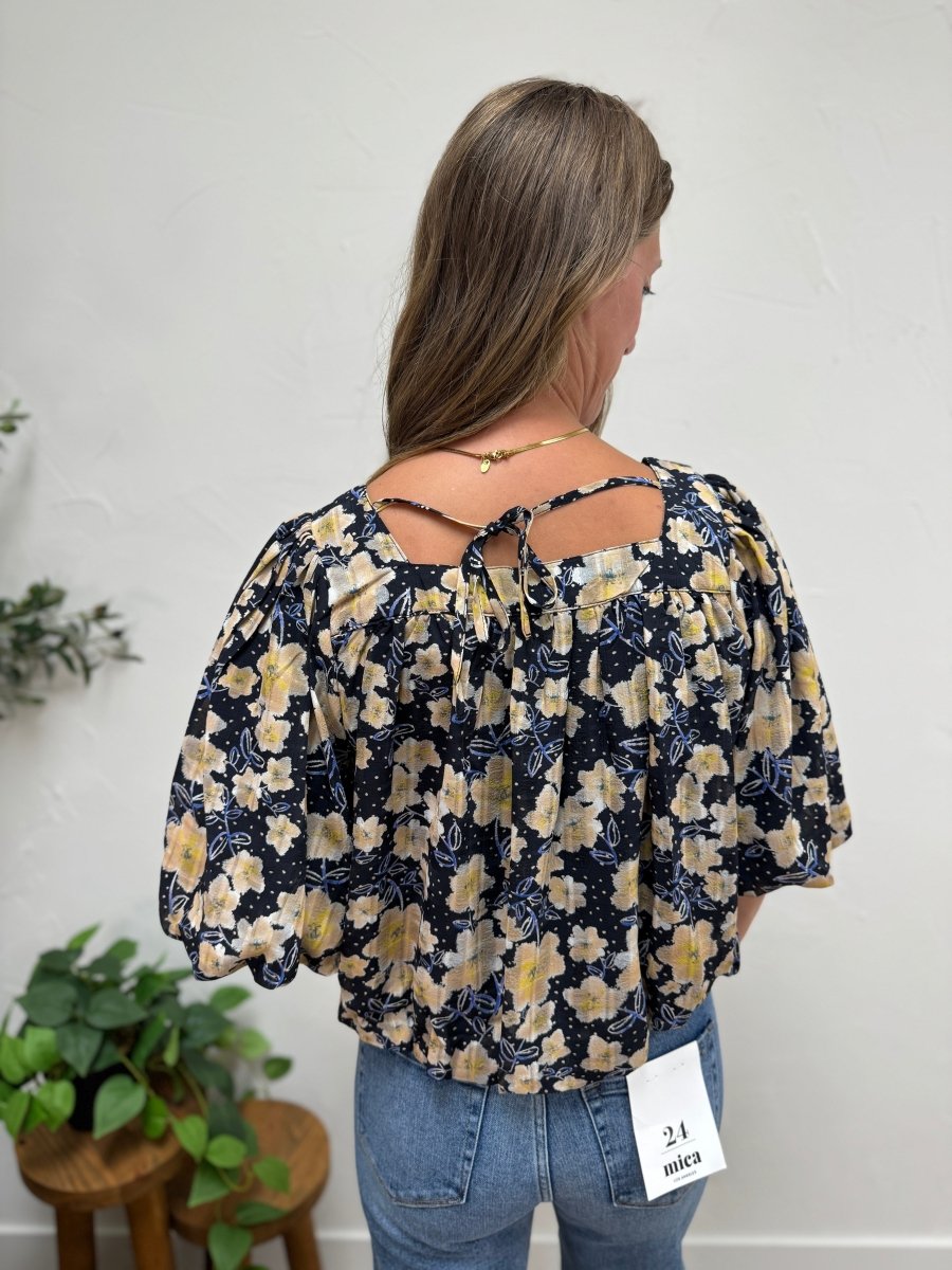 Back view of floral print balloon hem blouse on model — Three:Twelve Boutique