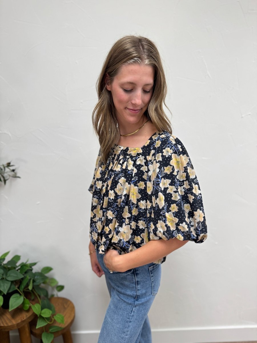 Side angle of black and butter floral blouse showing balloon hem detail — Three:Twelve Boutique