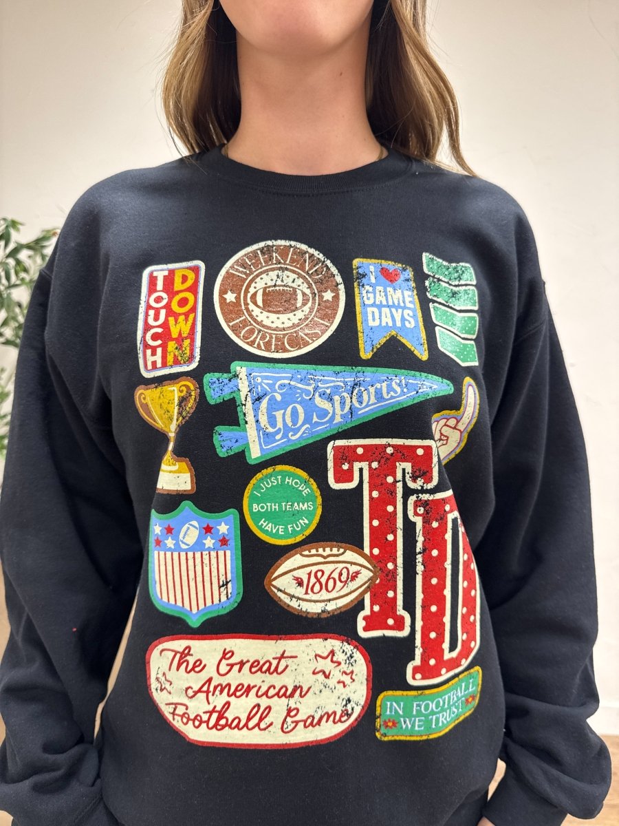 Close up of football varsity patch detail on sweatshirt fabric — Three:Twelve Boutique