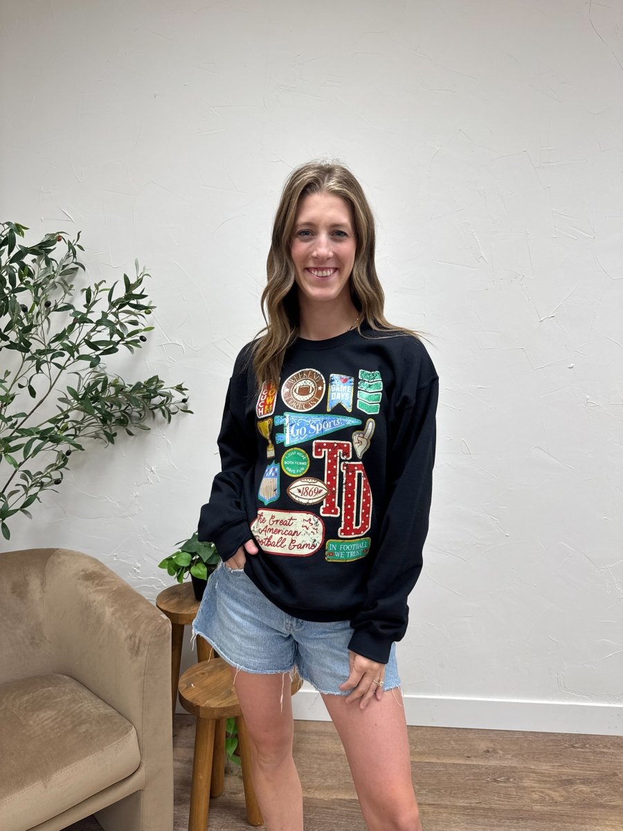 Lifestyle shot of model styling Football Varsity Patch sweatshirt with casual denim — Three:Twelve Boutique