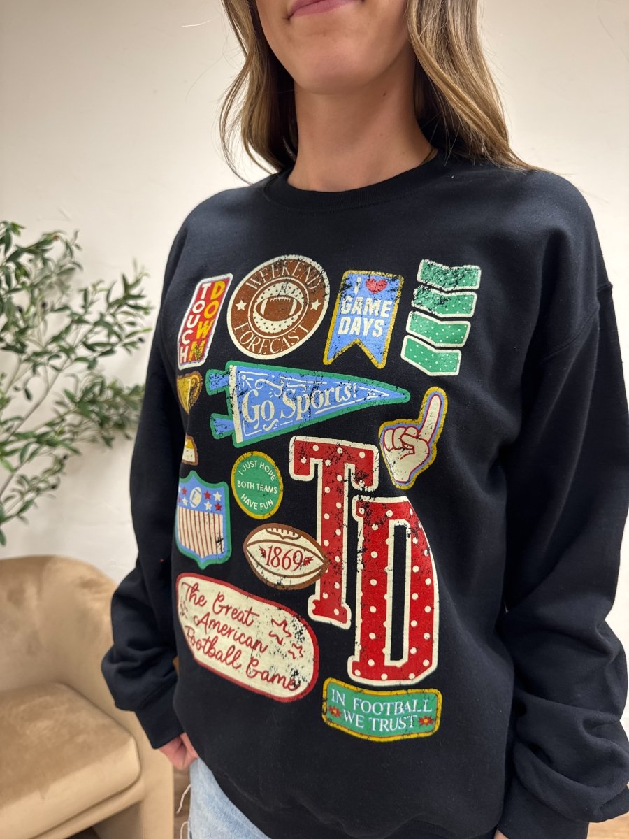 Close up of football varsity patch detail on sweatshirt fabric — Three:Twelve Boutique