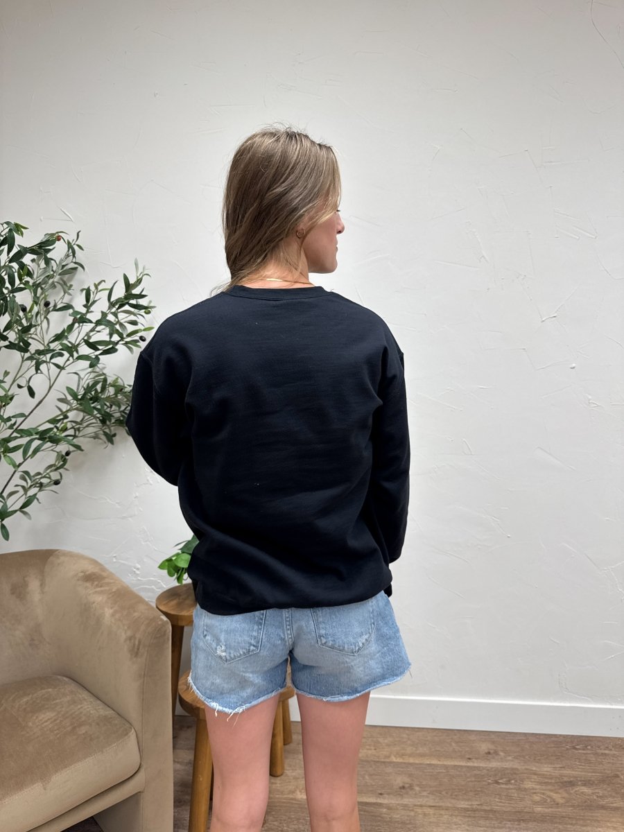 Back view of Football Varsity Patch sweatshirt on model showing relaxed silhouette — Three:Twelve Boutique