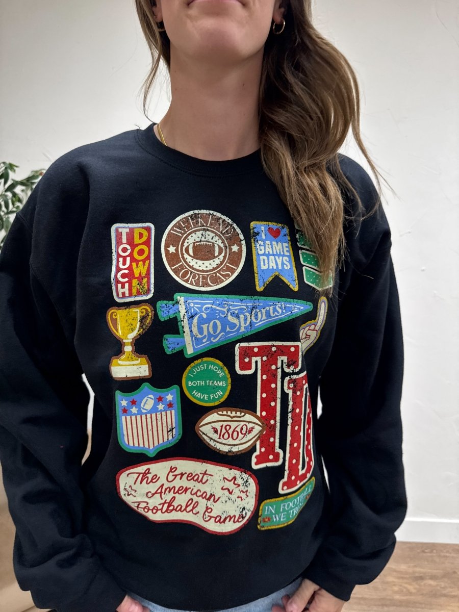 Close up of football varsity patch detail on sweatshirt fabric — Three:Twelve Boutique